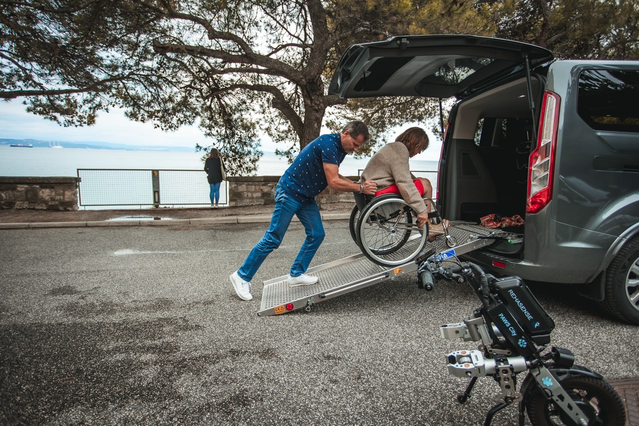 Wheelchair user boarding an adapted van using a ramp