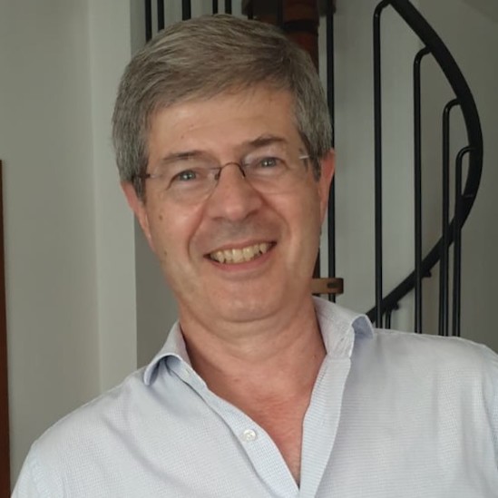 Portrait of Marco Canali, smiling, wearing a light blue shirt.