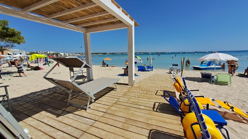 The beach setting with shaded roof and beach wheelchairs